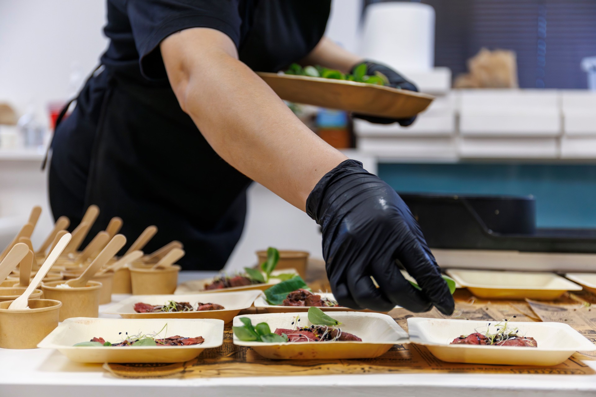 caterer preparing individual dishes for a corporate event